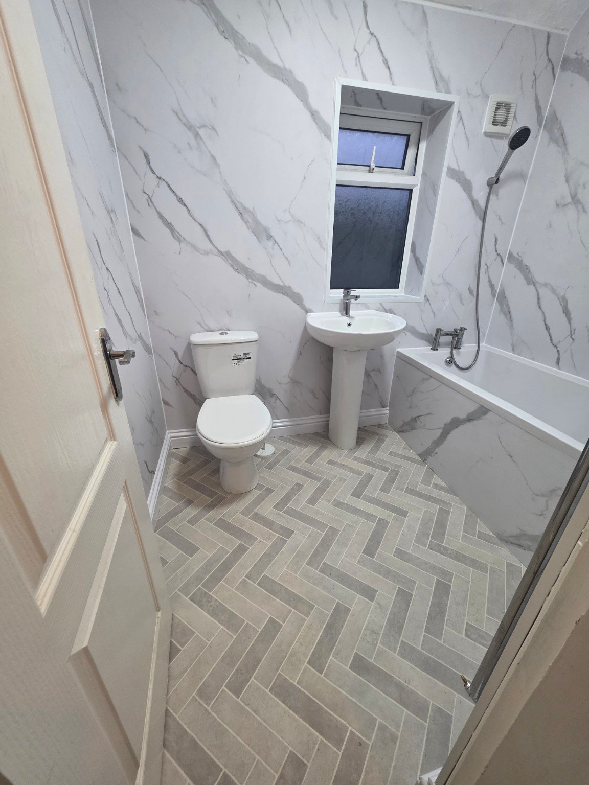 Completed full bathroom refurbishment with marble-effect shower boards