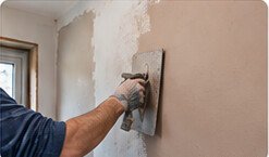 Plasterer preparing an interior wall